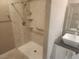 A shower with a rainfall showerhead, convenient grab bars, and corner shelves for toiletries at 2704 Willow Wren Dr, North Las Vegas, NV 89084