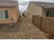 View of side yard with gravel and bamboo fence at 2704 Willow Wren Dr, North Las Vegas, NV 89084