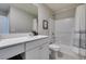 Bathroom featuring a single sink vanity, framed mirror, and a shower-tub combo at 2878 Starling Summit St, Henderson, NV 89044