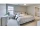 Neutral bedroom with large bed, side tables, modern decor, and view of the ensuite bath at 2878 Starling Summit St, Henderson, NV 89044