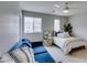 Comfortable bedroom featuring a bed, sofa, natural light, and ceiling fan at 2878 Starling Summit St, Henderson, NV 89044