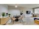 Open dining area with stylish chairs, modern lighting, and a view into the living room at 2878 Starling Summit St, Henderson, NV 89044