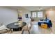 Dining space with modern furnishings, a round table, and a view of the living room at 2878 Starling Summit St, Henderson, NV 89044