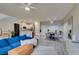 Open-concept living space with a large blue couch, dining area, and modern decor at 2878 Starling Summit St, Henderson, NV 89044