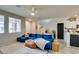 Bright living room featuring a plush blue sectional, neutral walls, and a cozy rug at 2878 Starling Summit St, Henderson, NV 89044