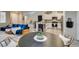 Modern living area showcasing an open floor plan with dining area, kitchen, and comfortable blue sofa at 2878 Starling Summit St, Henderson, NV 89044