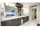 Modern bathroom featuring double sinks, marble countertops, and ample storage space at 3111 Bel Air Dr # 10F, Las Vegas, NV 89109