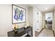 Entry hallway featuring a console table, modern art, and hardwood floors, leading to other rooms at 3111 Bel Air Dr # 10F, Las Vegas, NV 89109
