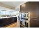 Modern kitchen with stainless steel appliances, dark cabinetry, breakfast bar seating and a view at 3111 Bel Air Dr # 10F, Las Vegas, NV 89109