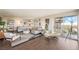 Inviting living room with a sectional, comfortable seating, hardwood floors and floor-to-ceiling windows offering city views at 3111 Bel Air Dr # 10F, Las Vegas, NV 89109