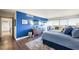 Bright main bedroom with a blue accent wall, balcony access, and hardwood flooring at 3111 Bel Air Dr # 10F, Las Vegas, NV 89109