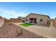 A large backyard with gravel, mulch, a small garden and turf area, great for entertaining at 378 Hellebores Ave, North Las Vegas, NV 89084