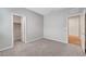 Bedroom with carpeted floors and two doorways, leading to closet and hallway at 378 Hellebores Ave, North Las Vegas, NV 89084