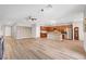 Open-concept living space with modern floors, a decorative wall, and an adjacent, well-equipped kitchen at 378 Hellebores Ave, North Las Vegas, NV 89084