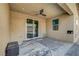A covered patio featuring stone floors, neutral tones, and an outdoor ceiling fan at 378 Hellebores Ave, North Las Vegas, NV 89084