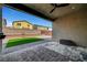 An outdoor patio featuring a ceiling fan and stone floor work with a view of a well-kept yard at 378 Hellebores Ave, North Las Vegas, NV 89084