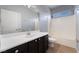 Well-lit bathroom with a dark vanity, a large mirror, and a shower-tub combination at 5100 Amethyst Creek Ct, Las Vegas, NV 89131