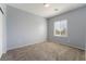 Neutral bedroom featuring plush carpeting, a window with blinds, and a minimalist aesthetic at 5100 Amethyst Creek Ct, Las Vegas, NV 89131