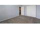 Comfortable bedroom featuring plush carpeting, a closet, and a doorway to the rest of the home at 5100 Amethyst Creek Ct, Las Vegas, NV 89131