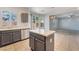Bright kitchen with an island, updated cabinets, stainless steel appliances, and tile floors at 5100 Amethyst Creek Ct, Las Vegas, NV 89131