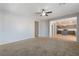 Open-concept living room with carpet, flowing into dining area and view of the gray kitchen at 5100 Amethyst Creek Ct, Las Vegas, NV 89131