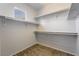 Spacious walk-in closet featuring carpeted flooring and multiple levels of shelving for optimal storage at 5100 Amethyst Creek Ct, Las Vegas, NV 89131