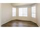 Cozy bedroom with wood flooring and three windows providing ample natural light at 5127 Fiji Island Ct, North Las Vegas, NV 89031
