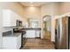 Modern kitchen featuring stainless steel appliances, white cabinets, and wood floors at 5127 Fiji Island Ct, North Las Vegas, NV 89031