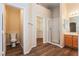 Bathroom featuring dual sinks, a separate toilet room, and a walk-in closet at 5127 Fiji Island Ct, North Las Vegas, NV 89031