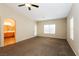 Large primary bedroom with plush carpeting, natural light, and en suite bathroom at 5127 Fiji Island Ct, North Las Vegas, NV 89031