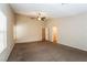 Spacious main bedroom featuring neutral walls, ceiling fan, and plush carpeting throughout at 5127 Fiji Island Ct, North Las Vegas, NV 89031