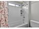 Bright white bathroom with tub-shower combination and storage at 5232 Mountain Garland Ln, North Las Vegas, NV 89081