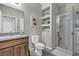 Stylish bathroom featuring a glass-enclosed shower, floating shelves, and modern fixtures at 5232 Mountain Garland Ln, North Las Vegas, NV 89081
