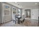 Bright dining room features a modern table with upholstered chairs and large windows for natural light at 5232 Mountain Garland Ln, North Las Vegas, NV 89081