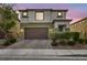 Two story home with a two car garage and landscaped yard, enhancing the property's curb appeal at 5232 Mountain Garland Ln, North Las Vegas, NV 89081