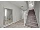 Hallway with staircase featuring carpeted steps, a large mirror, and neutral paint at 5232 Mountain Garland Ln, North Las Vegas, NV 89081