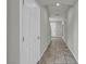 Hallway features tile flooring, white walls, and a view of the front door at 5232 Mountain Garland Ln, North Las Vegas, NV 89081