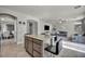 Open concept kitchen with granite countertops, stainless steel appliances, and seamlessly connected to the living room at 5232 Mountain Garland Ln, North Las Vegas, NV 89081