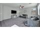 Bright living room featuring plush sofas, a ceiling fan, and large windows for natural light at 5232 Mountain Garland Ln, North Las Vegas, NV 89081