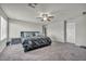 A large bedroom features neutral paint, carpet, and a ceiling fan for maximum comfort at 5232 Mountain Garland Ln, North Las Vegas, NV 89081