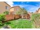 A verdant backyard with healthy lawn and a planter bed and retaining wall at 5513 Nickel Ridge Way, Las Vegas, NV 89122