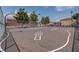 Well-maintained community basketball court with hopscotch and mature trees in the background at 5513 Nickel Ridge Way, Las Vegas, NV 89122