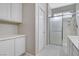 Bright bathroom featuring a glass shower enclosure and cabinet space, with clean, neutral finishes at 5513 Nickel Ridge Way, Las Vegas, NV 89122