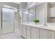 Clean bathroom with double vanity, shower and plant detail at 5513 Nickel Ridge Way, Las Vegas, NV 89122