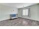Bedroom featuring a crib, window with blinds, and wood-look floors at 5513 Nickel Ridge Way, Las Vegas, NV 89122