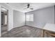 Bright bedroom features wood-look floors, a window and ceiling fan at 5513 Nickel Ridge Way, Las Vegas, NV 89122