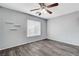 Bedroom featuring wood-look floors, a window, and modern wall accents at 5513 Nickel Ridge Way, Las Vegas, NV 89122
