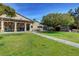 Community clubhouse surrounded by manicured lawn and picnic tables for residents' enjoyment at 5513 Nickel Ridge Way, Las Vegas, NV 89122