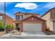 Inviting two-story home with a tile roof, stucco facade, and a well-manicured front yard at 5513 Nickel Ridge Way, Las Vegas, NV 89122