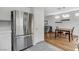 Modern kitchen with stainless steel refrigerator and a view into the dining area at 5513 Nickel Ridge Way, Las Vegas, NV 89122